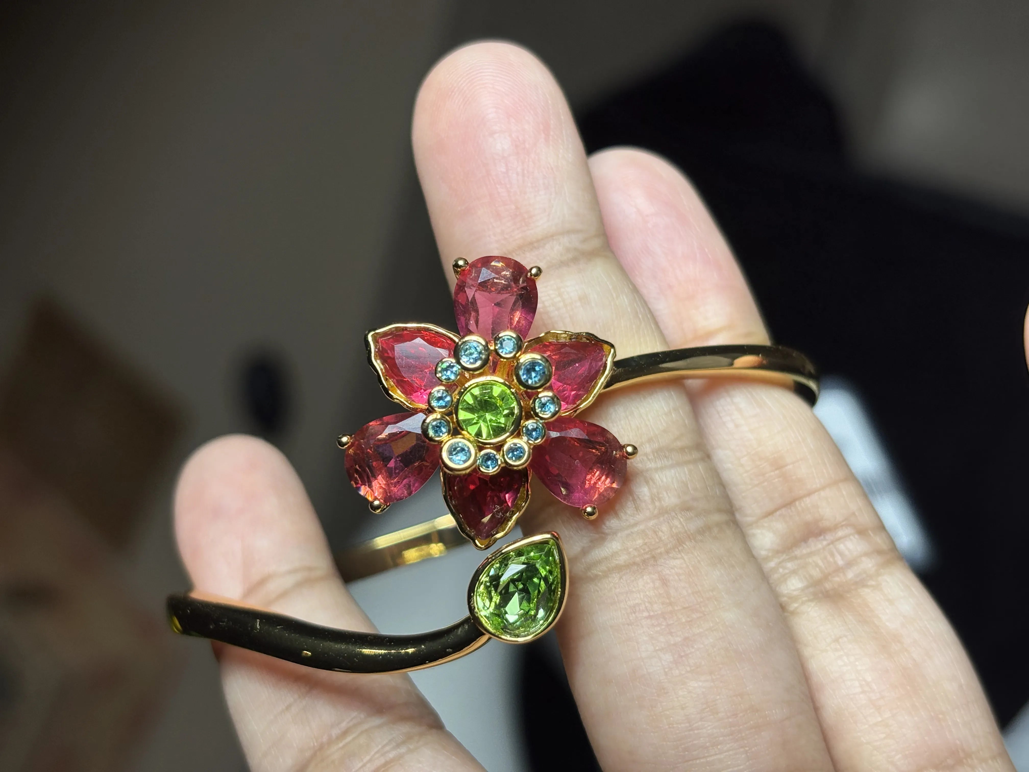 Jewelry with gemstones on a finger against a blurred background